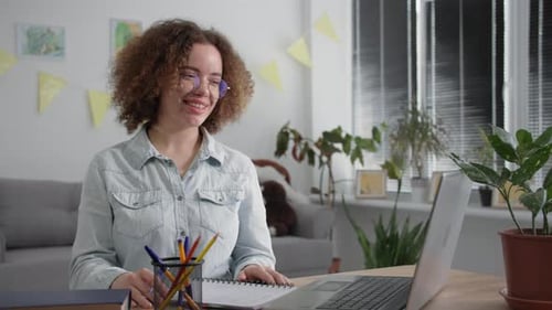 Office Online Young Woman in Glasses Undergoes Distance Learning Talking with Teacher By Video