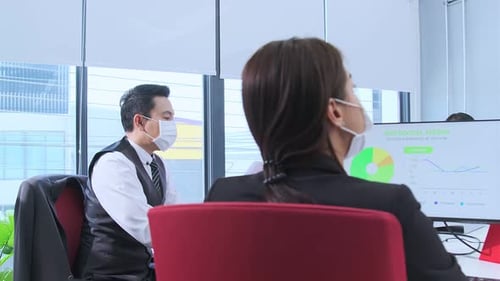 Businesspeople with face masks in the office during COVID-19 pandemic