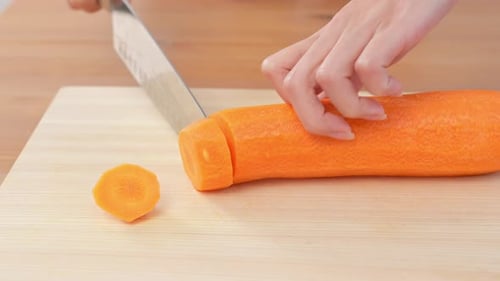 Slicing Carrots on Wooden Cutting Board