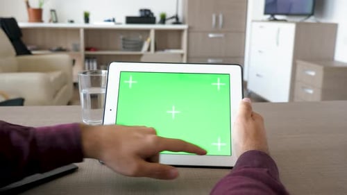 Hands Using Tablet with Green Screen Display