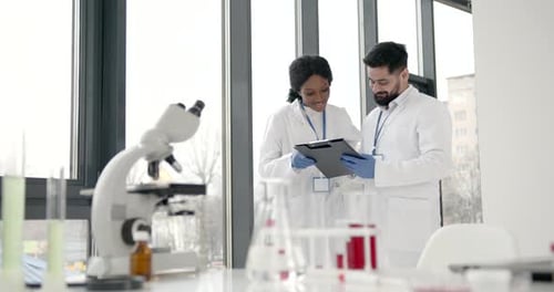 Scientists Collaborating in Modern Bright Laboratory