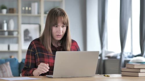 Woman Works on Laptop in Home Office