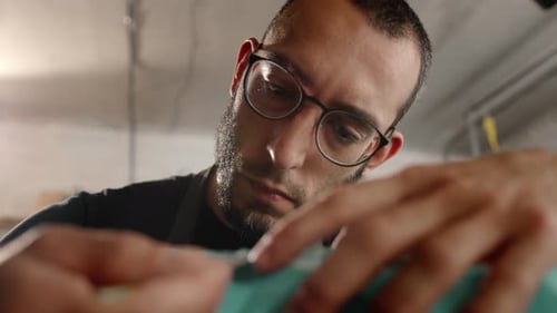 Close-up: a man works with a blade. Production of decorative elements. Workshop.