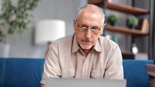 Senior Man Working on Laptop at Home