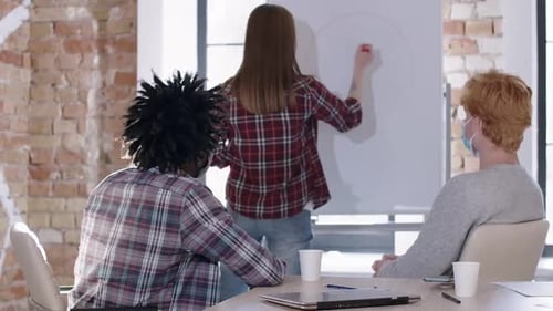 Colleagues Discussing Data Presentation in an Office