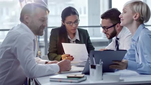 Office Team Discusses Data and Planning at Table