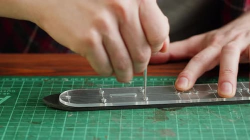 Man Tailor Marking Artificial Leather with Stencil Closeup