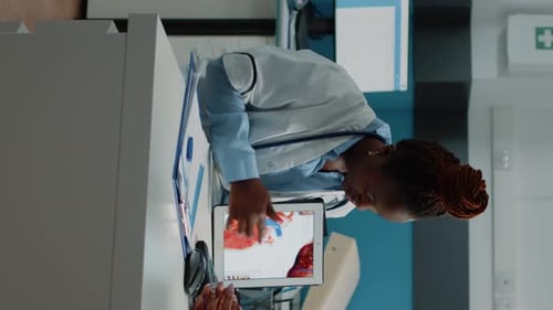 Doctor Explains Heart Diagram to Patient in Office