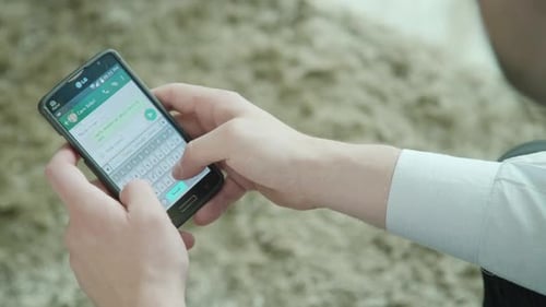 Close Up of Man Texting on Smartphone