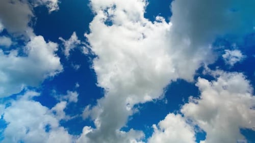 White Clouds Moving Across a Bright Blue Sky