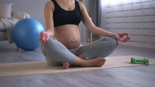 Healthcare and Prenatal Yoga Woman with Bare Belly Meditates Spbd