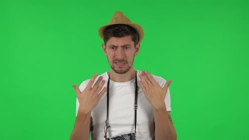 Man expressing sadness on a green screen