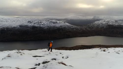 Mountain Walker Exploring Snowy Area with Beautiful Landscape