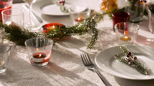 Festive Christmas Table Setting with Candles and Wine