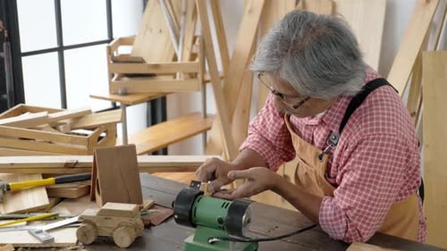Woodworker Carefully Shapes Wood in His Shop