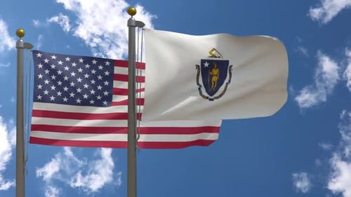 American and Massachusetts State Flags Waving Against Blue Sky