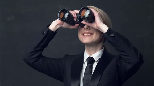 Woman Looks Through Binoculars in Business Suit