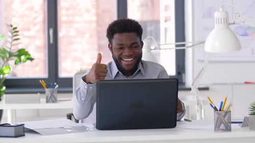 Businessman Having Video Chat on Laptop at Office 33
