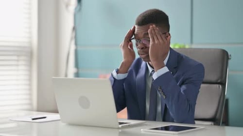 Young Adult Working at Computer Experiencing Stress