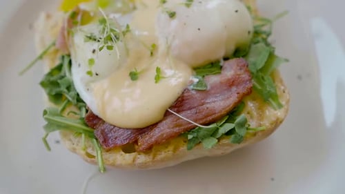Eggs Benedict with Bread and Tomato on a Plate with Becon Morning Sandwich