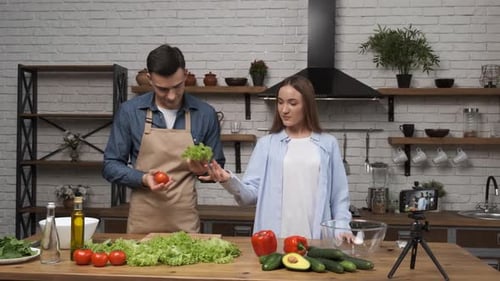Young Food Bloggers Are Preparing To Cook a Salad By Filming the Whole Process with a Phone Camera