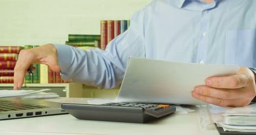 Male Hands with Documents a Man at the Workplace in the Office Checks Documents