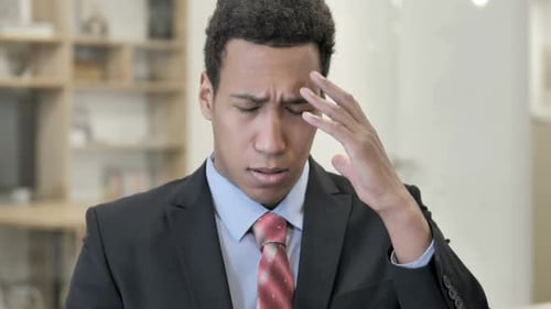 Young Adult Experiencing Headache in Office Close Up