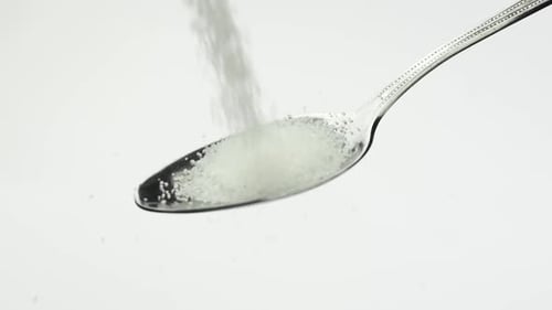 Very Beautiful Stunning Bright White Sugar Sugar Crumbles Into a Shiny Teaspoon