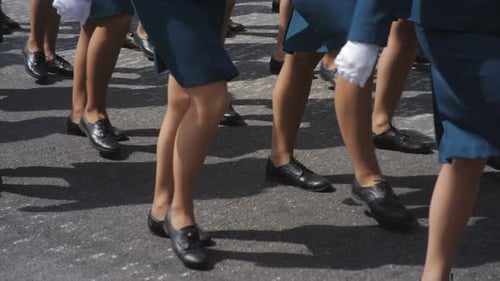 Military Women March in Parade in Green Uniform on the Town Square