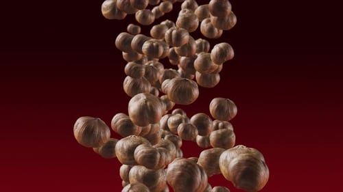 Hazelnuts Falling Against a Red Background