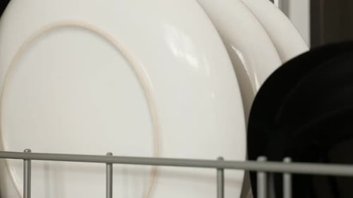 Plate Placed in a Dishwasher Rack Close Up