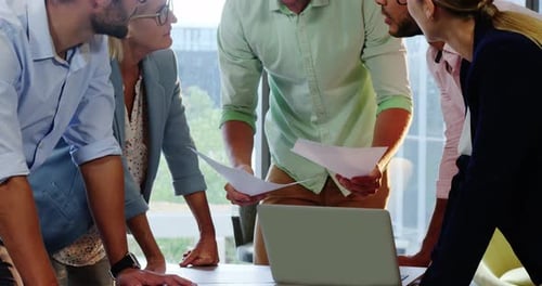 Professionals Discussing Business Around a Table