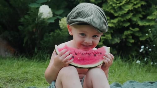 Boy Eating Watermelon Outside in Summer