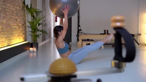 Woman doing abs exercises with fitness ball