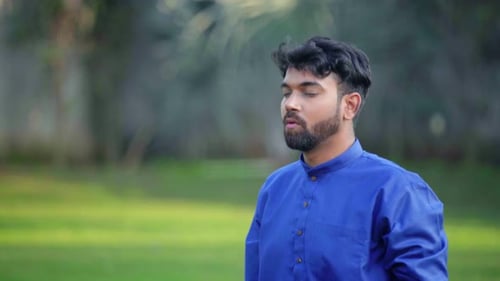 Indian man chanting Om and doing yoga and meditation in an Indian traditional outfit Kurta Pajama