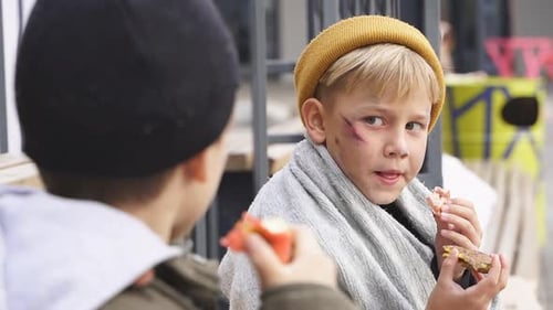 Two Homeless Boys Sit Eating Food Bench Little Caucasian Children Street Kids Are Hungry