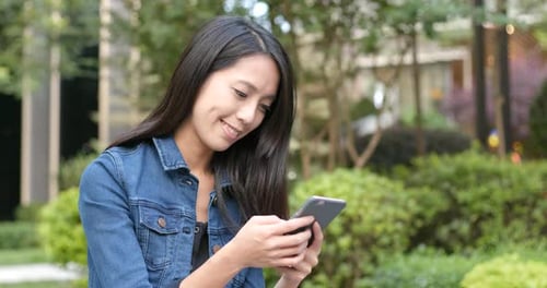 Woman use of smart phone in the park