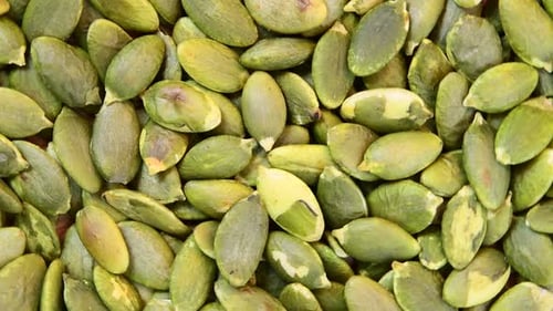 Heap of Fresh Green Pumpkin Seeds Close Up
