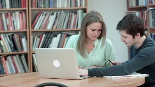 High School Student Working in Library After Classes, Using Laptop