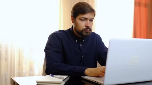 Man Working at Laptop in Home Office