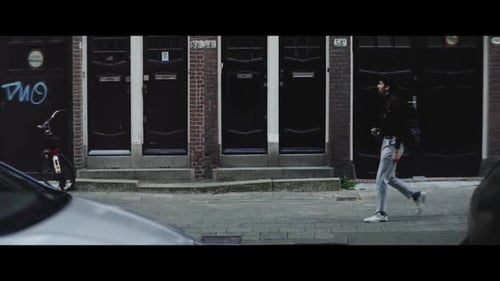 Young caucasian man walking and taking photos in the city