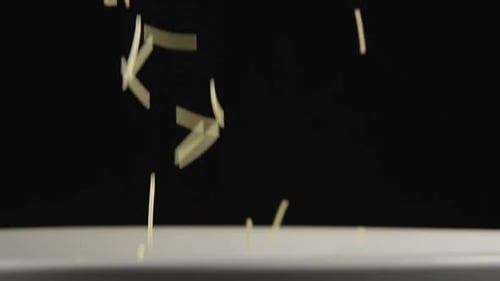 Uncooked Pasta Falling in Slow Motion