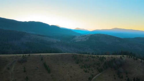 Beautiful Mountain Panoramic Landscape with Hazy Peaks and Foggy Valley at Sunset
