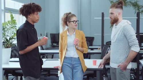 Team of Employees Chatting at Coffee Break in Office