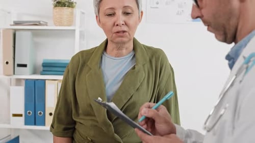 Doctor Consults with Senior Woman in Office