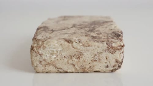 Sesame halva with cocoa on white 4K footage