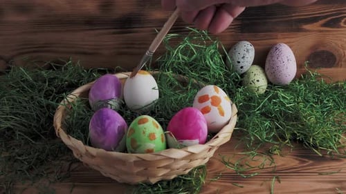 Decorating Colorful Easter Eggs with Brown Paint