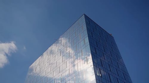 Modern building on sky background. Architecture in the city. Glass construction. Urban tall center