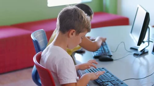 School kids using computer in classroom