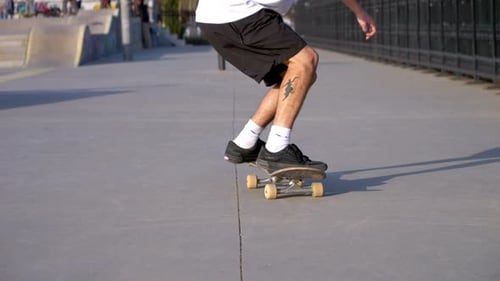 Young Adult Skateboarding Trick in Urban Skate Park
